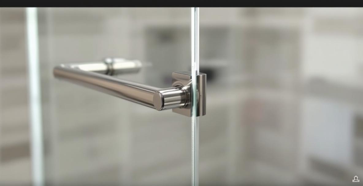 Selection of shower door pull and knob styles on frameless glass including round knob, C-pull, and bar pull options